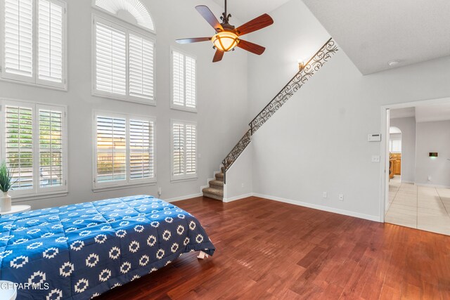 6308 Franklin Vis, El Paso, TX 79912 - bedroom featuring a high ceiling, wood finished floors, baseboards, and ceiling fan