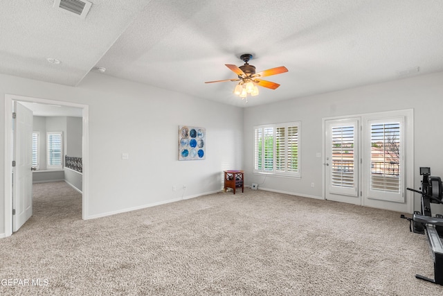 6308 Franklin Vis, El Paso, TX 79912 - empty room with carpet flooring, a ceiling fan, a textured ceiling, plenty of natural light, and baseboards