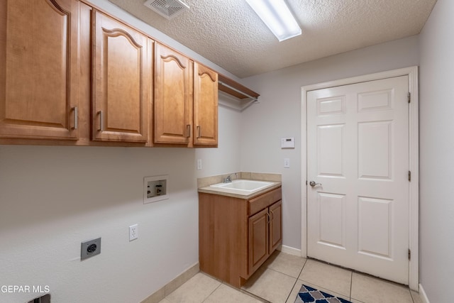 6308 Franklin Vis, El Paso, TX 79912 - washroom with electric dryer hookup, cabinet space, washer hookup, a textured ceiling, and baseboards