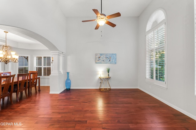 6308 Franklin Vis, El Paso, TX 79912 - dining area featuring arched walkways, a ceiling fan, wood finished floors, plenty of natural light, and a high ceiling