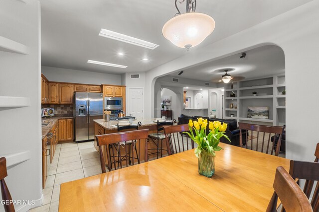 6308 Franklin Vis, El Paso, TX 79912 - dining area with arched walkways, light tile patterned floors, and a ceiling fan