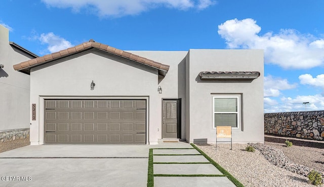 3936 Aspiration, El Paso, TX 79938 - view of front facade with an attached garage, concrete driveway, and stucco siding