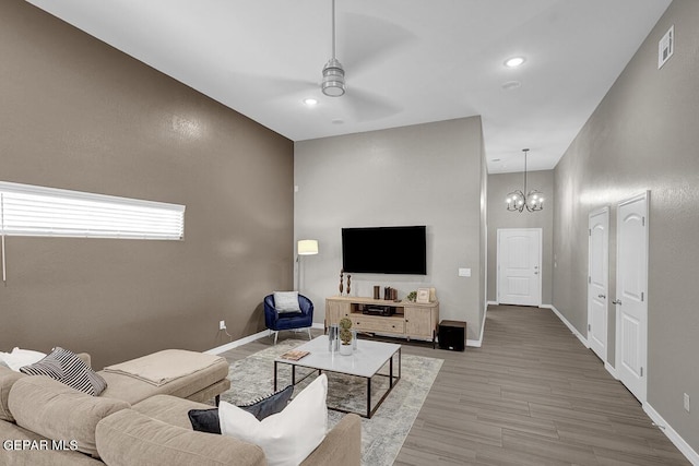 3936 Aspiration, El Paso, TX 79938 - living room with ceiling fan, wood finished floors, baseboards, a chandelier, and recessed lighting