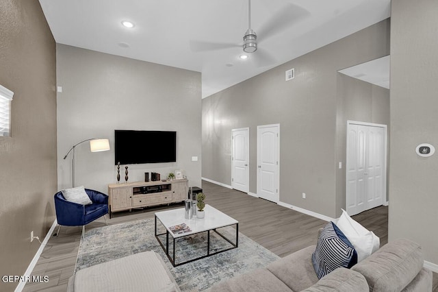 3936 Aspiration, El Paso, TX 79938 - living room featuring a ceiling fan, baseboards, wood finished floors, recessed lighting, and a high ceiling