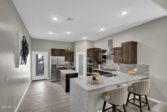 3936 Aspiration, El Paso, TX 79938 - kitchen featuring stainless steel appliances, extractor fan, baseboards, a peninsula, and recessed lighting