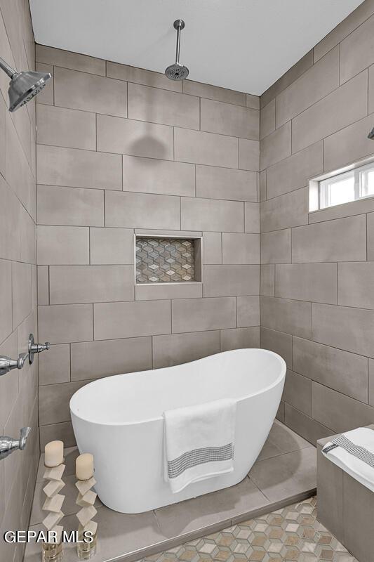 3936 Aspiration, El Paso, TX 79938 - bathroom featuring a freestanding bath, tile patterned floors, tile walls, and a tile shower