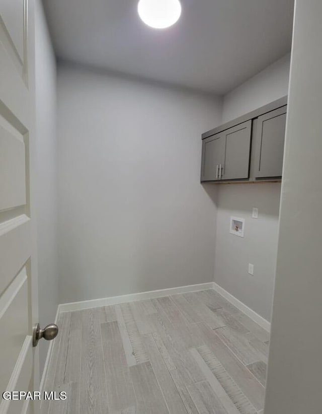 497 Plateau Dr, Socorro, TX 79927 - laundry room with cabinet space, washer hookup, light wood finished floors, and baseboards