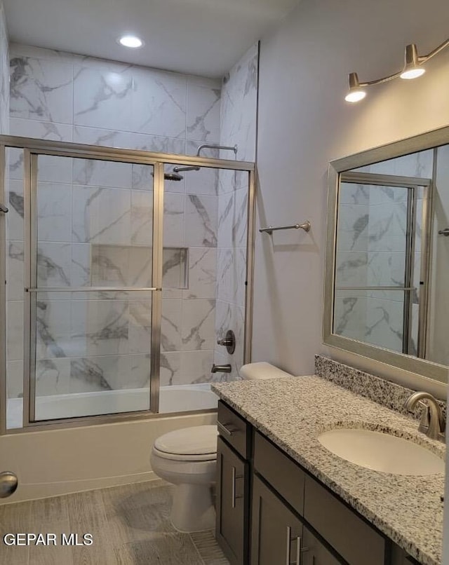 497 Plateau Dr, Socorro, TX 79927 - bathroom featuring toilet, vanity, combined bath / shower with glass door, and recessed lighting
