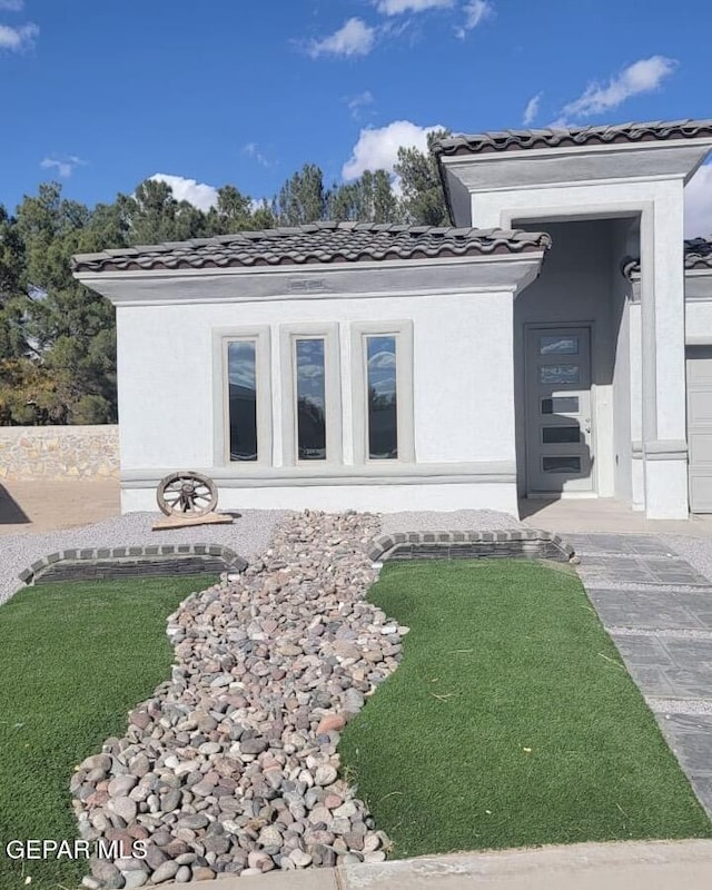 497 Plateau Dr, Socorro, TX 79927 - view of property exterior featuring a tiled roof and stucco siding
