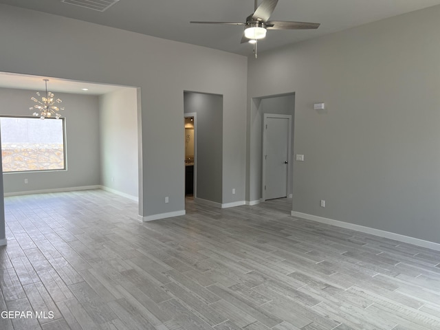 497 Plateau Dr, Socorro, TX 79927 - unfurnished room with a ceiling fan, a chandelier, light wood-type flooring, and baseboards