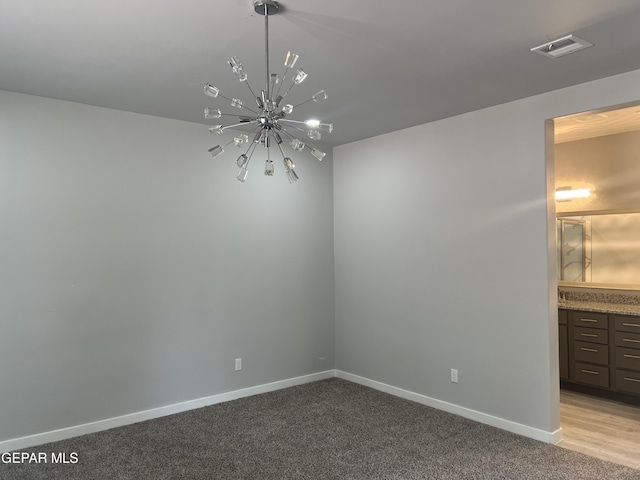 497 Plateau Dr, Socorro, TX 79927 - unfurnished dining area featuring a chandelier, light carpet, and baseboards