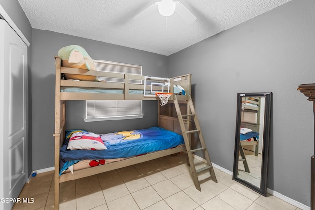 2297 Lisa Sherr St, El Paso, TX 79938 - tiled bedroom featuring a textured ceiling, ceiling fan, and baseboards