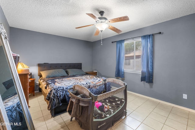 2297 Lisa Sherr St, El Paso, TX 79938 - tiled bedroom featuring a textured ceiling, ceiling fan, and baseboards