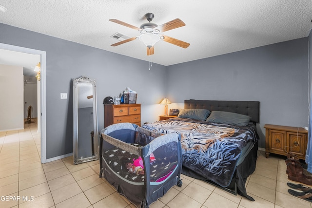 2297 Lisa Sherr St, El Paso, TX 79938 - tiled bedroom with a textured ceiling, ceiling fan, and baseboards
