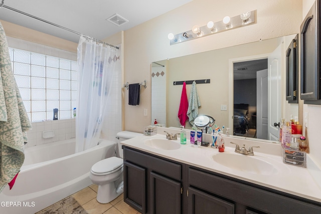 2297 Lisa Sherr St, El Paso, TX 79938 - ensuite bathroom featuring tile patterned flooring, double vanity, shower / bath combo with shower curtain, and toilet