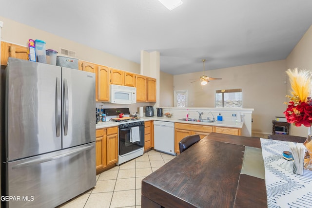 2297 Lisa Sherr St, El Paso, TX 79938 - kitchen with white appliances, a sink, a peninsula, light tile patterned floors, and a ceiling fan