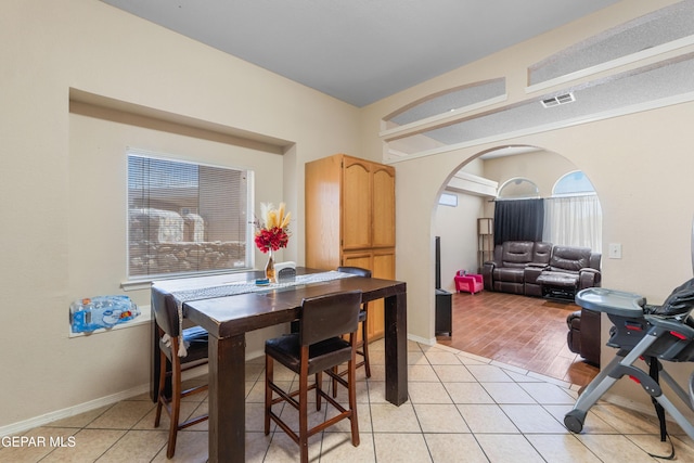 2297 Lisa Sherr St, El Paso, TX 79938 - dining space with arched walkways and light tile patterned floors