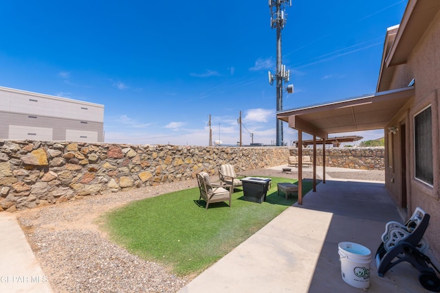 2297 Lisa Sherr St, El Paso, TX 79938 - fenced backyard with a patio and a fire pit
