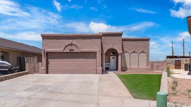 2297 Lisa Sherr St, El Paso, TX 79938 - view of front facade featuring a garage, concrete driveway, a gate, stucco siding, and central AC