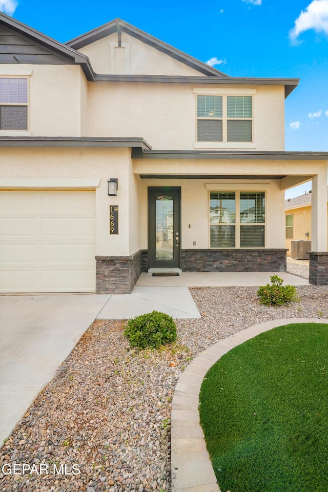 1669 Sam Dominguez, El Paso, TX 79928 - view of front of property featuring a porch, stucco siding, stone siding, concrete driveway, and an attached garage