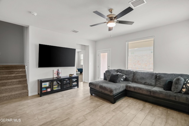 1669 Sam Dominguez, El Paso, TX 79928 - living area with light wood-type flooring, stairs, ceiling fan, and healthy amount of natural light