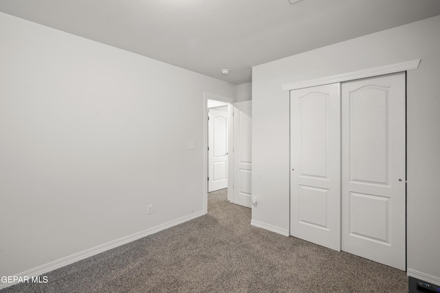 1669 Sam Dominguez, El Paso, TX 79928 - unfurnished bedroom featuring dark carpet, a closet, and baseboards
