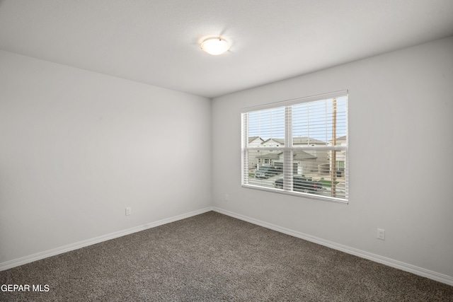 1669 Sam Dominguez, El Paso, TX 79928 - empty room with dark carpet and baseboards