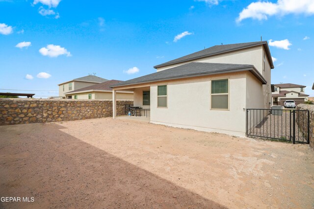 1669 Sam Dominguez, El Paso, TX 79928 - rear view of house with stucco siding, a patio area, and a shingled roof