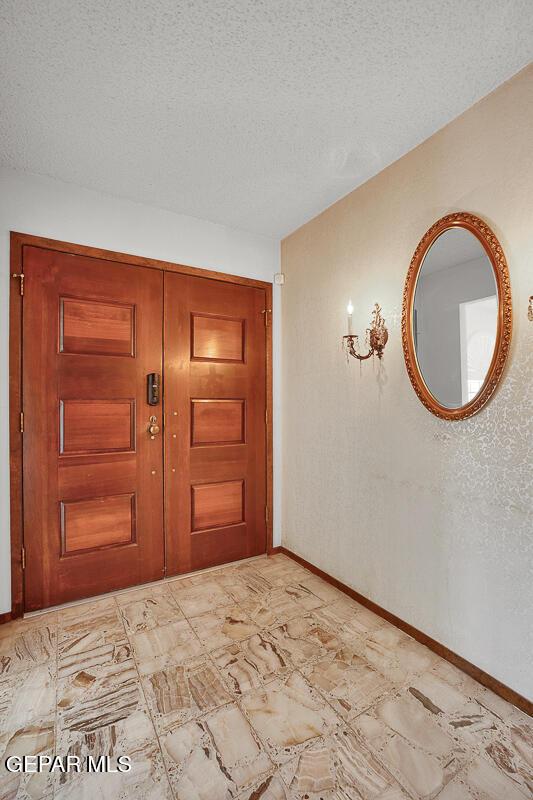 1126 Loma Verde Dr, El Paso, TX 79936 - entrance foyer with baseboards and a textured ceiling