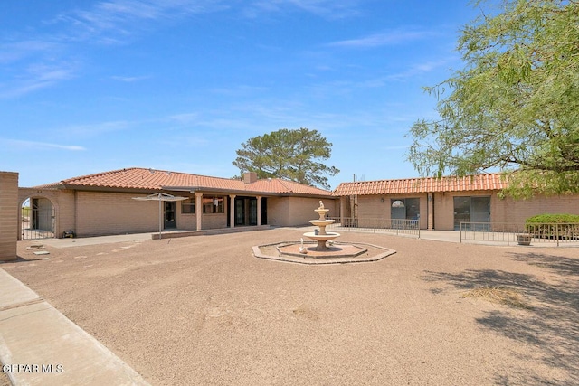 1126 Loma Verde Dr, El Paso, TX 79936 - rear view of house with a tile roof and brick siding