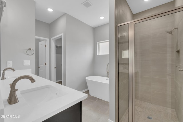 13813 Summer Hail Ave, El Paso, TX 79928 - full bathroom with a shower stall, double vanity, a freestanding bath, recessed lighting, and tile patterned floors