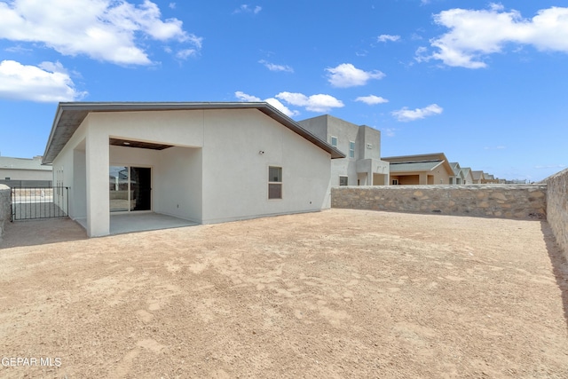 13813 Summer Hail Ave, El Paso, TX 79928 - rear view of house with stucco siding, a patio area, and a fenced backyard