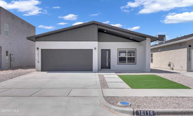 13865 Summer Wave Ave, Horizon City, TX 79928 - view of front of home with a garage, driveway, and stucco siding