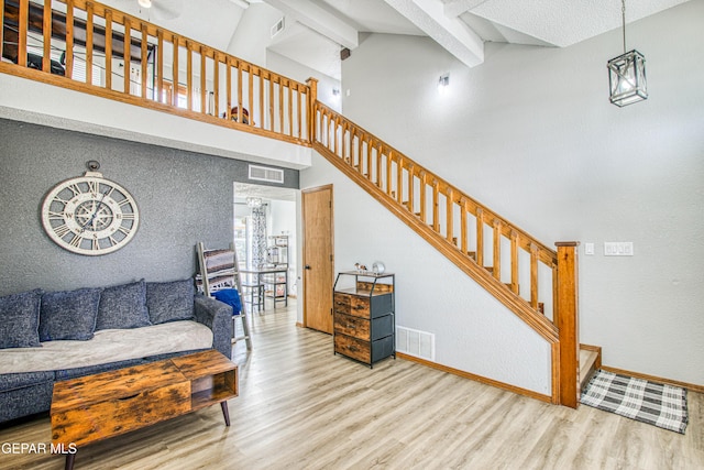 4521 Loma De Plata Dr, El Paso, TX 79934 - stairs featuring wood finished floors, beamed ceiling, baseboards, and high vaulted ceiling