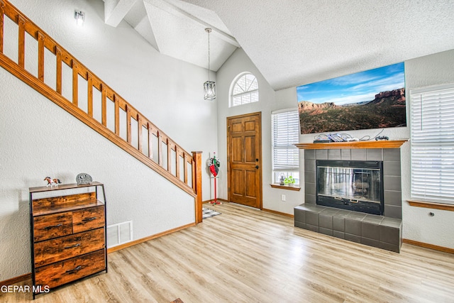 4521 Loma De Plata Dr, El Paso, TX 79934 - foyer with wood finished floors, baseboards, stairway, a textured wall, and a textured ceiling