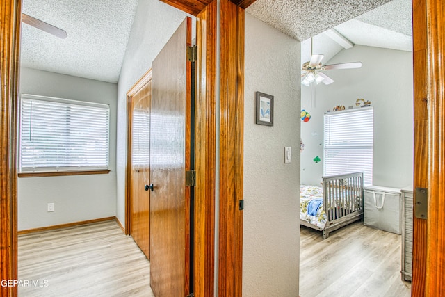 4521 Loma De Plata Dr, El Paso, TX 79934 - hallway with a textured ceiling, wood finished floors, a textured wall, and baseboards