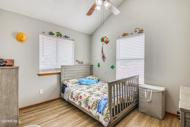 4521 Loma De Plata Dr, El Paso, TX 79934 - bedroom with vaulted ceiling, wood finished floors, baseboards, ceiling fan, and a textured ceiling