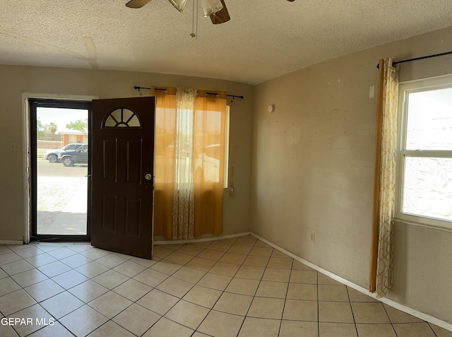 7800 Monterrey Dr, El Paso, TX 79915 - entryway with a ceiling fan, healthy amount of natural light, a textured ceiling, and light tile patterned flooring