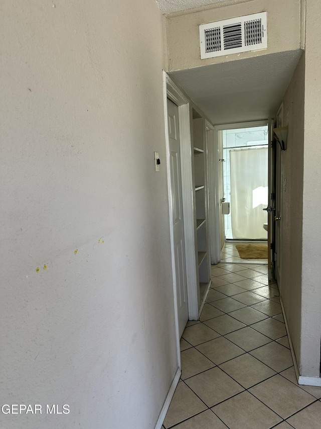 7800 Monterrey Dr, El Paso, TX 79915 - corridor with light tile patterned floors and baseboards