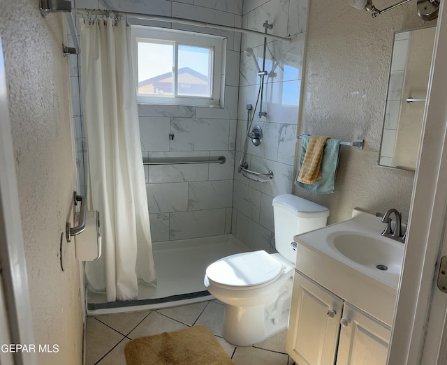 7800 Monterrey Dr, El Paso, TX 79915 - full bathroom with a textured wall, toilet, a stall shower, vanity, and tile patterned flooring