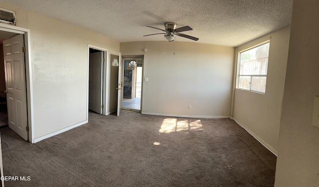 7800 Monterrey Dr, El Paso, TX 79915 - unfurnished bedroom featuring carpet flooring, a textured ceiling, a ceiling fan, and baseboards