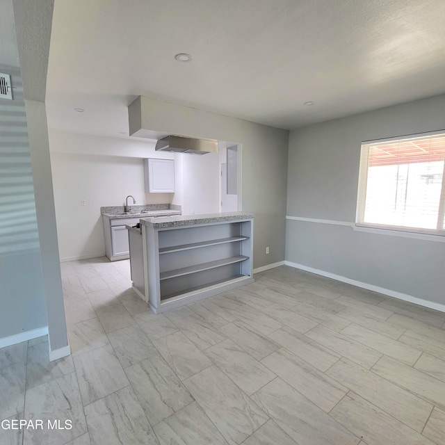 2916 Beachcomber, El Paso, TX 79936 - unfurnished living room with baseboards, a sink, light marble finish flooring, and recessed lighting