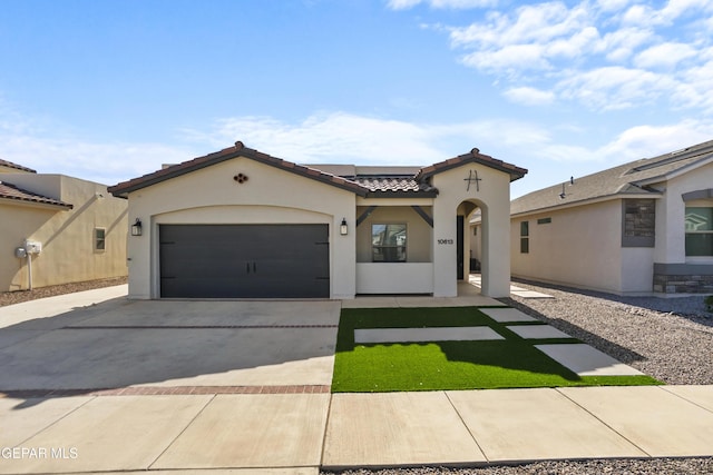 10613 Hidden Palm Dr, El Paso, TX 79924 - mediterranean / spanish house with stucco siding, driveway, a tiled roof, and an attached garage