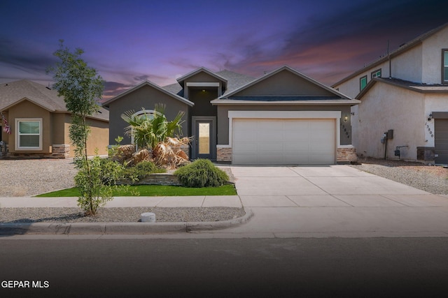 13804 Sky Ranger Ave, Horizon City, TX 79928 - view of front of house with stucco siding, concrete driveway, a garage, and stone siding