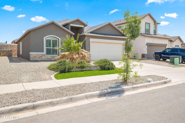 13804 Sky Ranger Ave, Horizon City, TX 79928 - view of front of home featuring stucco siding, concrete driveway, and stone siding
