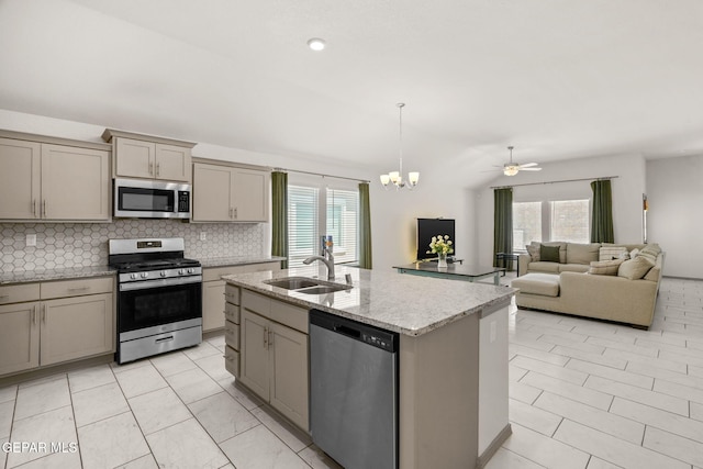 13804 Sky Ranger Ave, Horizon City, TX 79928 - kitchen featuring appliances with stainless steel finishes, gray cabinets, a sink, tasteful backsplash, and plenty of natural light