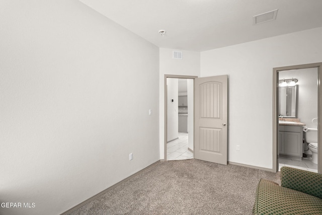 13804 Sky Ranger Ave, Horizon City, TX 79928 - unfurnished bedroom with light colored carpet, baseboards, and ensuite bath