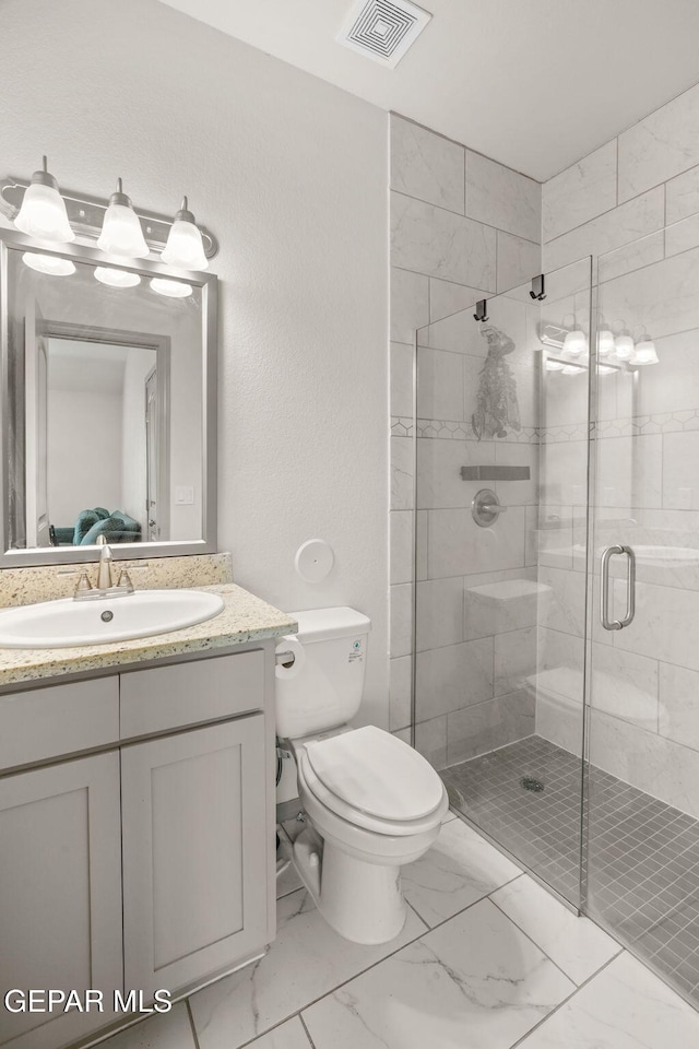 13804 Sky Ranger Ave, Horizon City, TX 79928 - bathroom featuring toilet, a shower stall, vanity, and marble finish flooring
