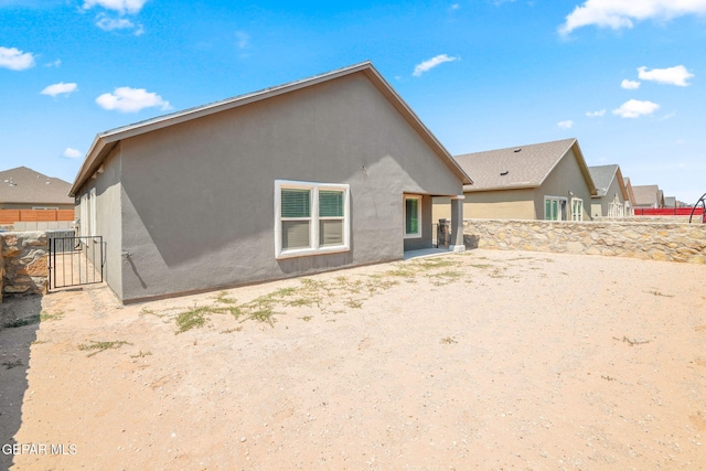 13804 Sky Ranger Ave, Horizon City, TX 79928 - rear view of house featuring stucco siding and a gate