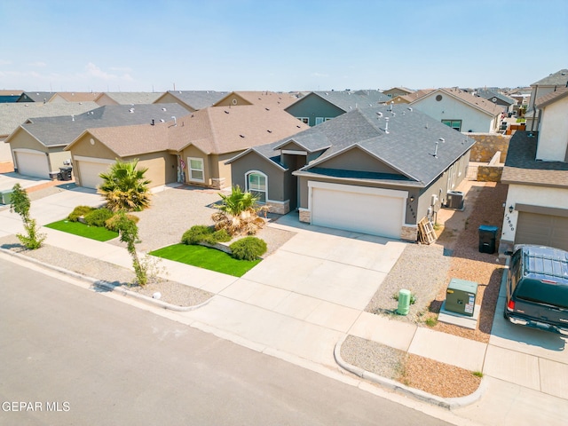 13804 Sky Ranger Ave, Horizon City, TX 79928 - view of front of home with a residential view, stucco siding, driveway, a garage, and stone siding